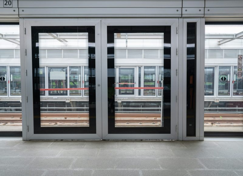 an empty train station with two doors open